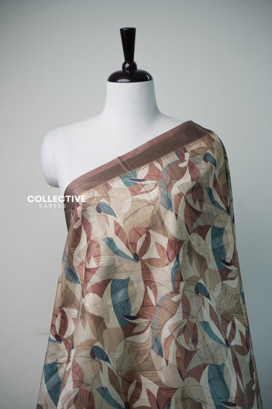 Close-up of leaf print and zari temple border on champagne gold dupion saree