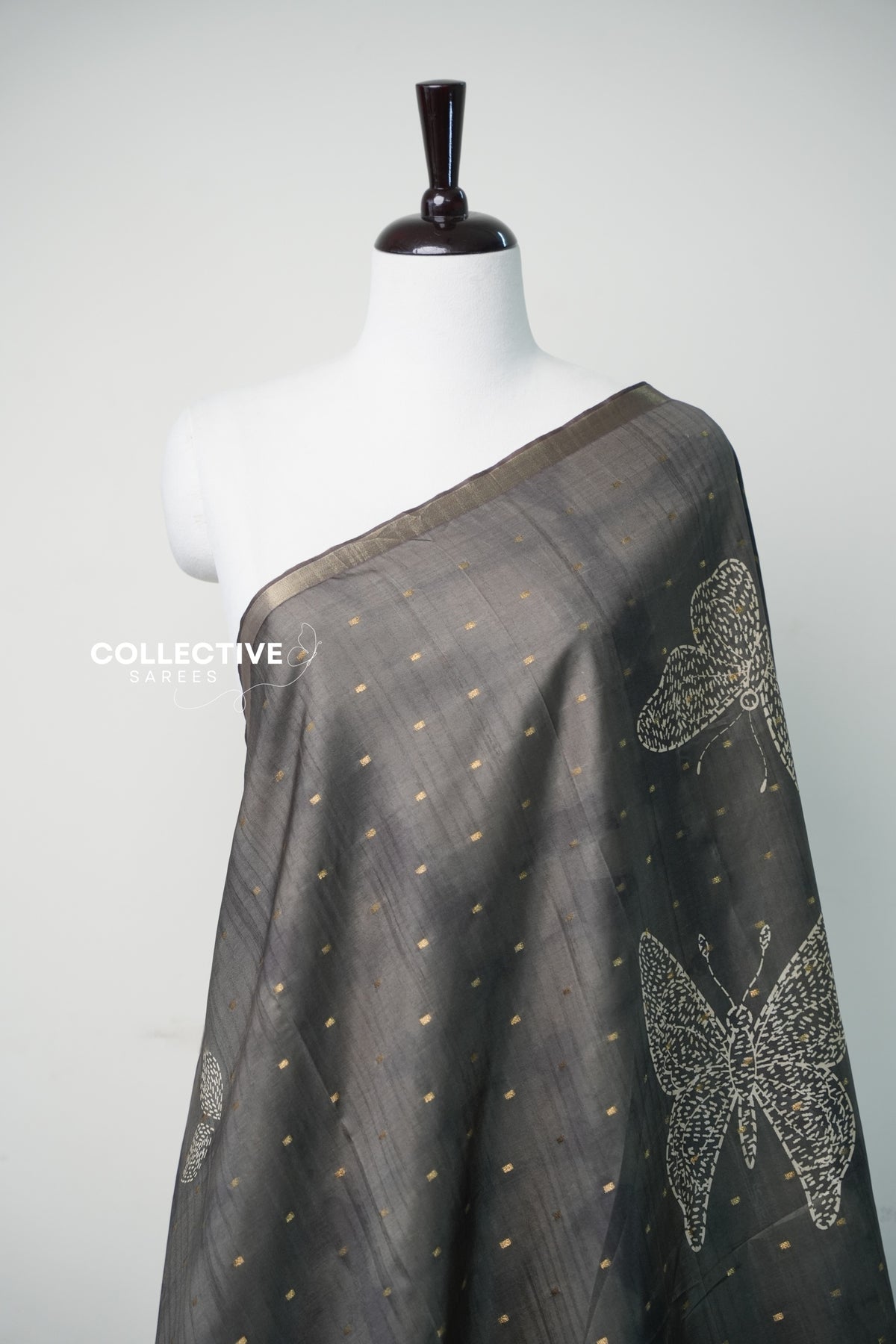Teal green dupion silk saree with gold zari buttis and butterfly motif close-up