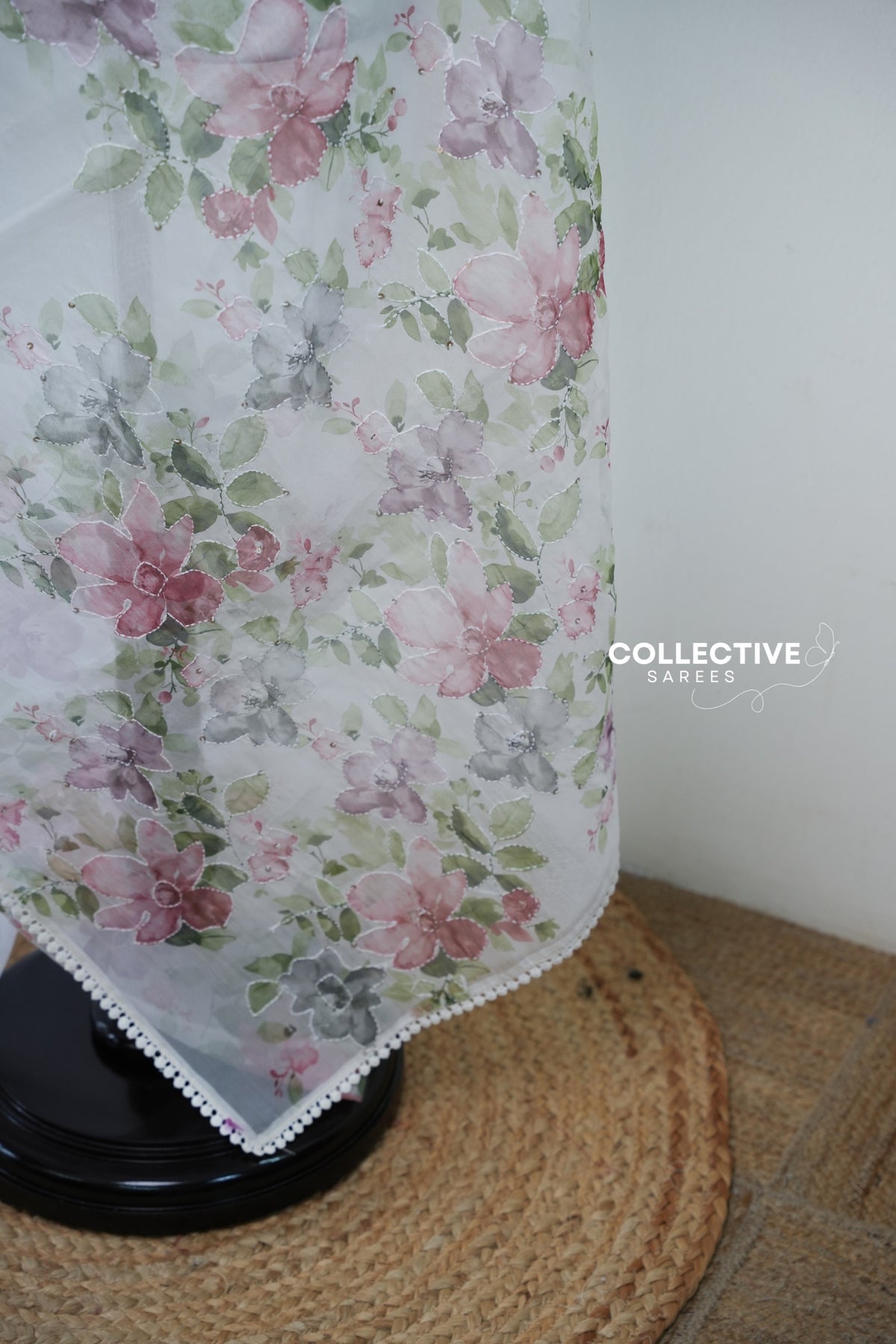 Watercolour pink, mauve and grey floral pallu with running stitch and lace border on white organza saree