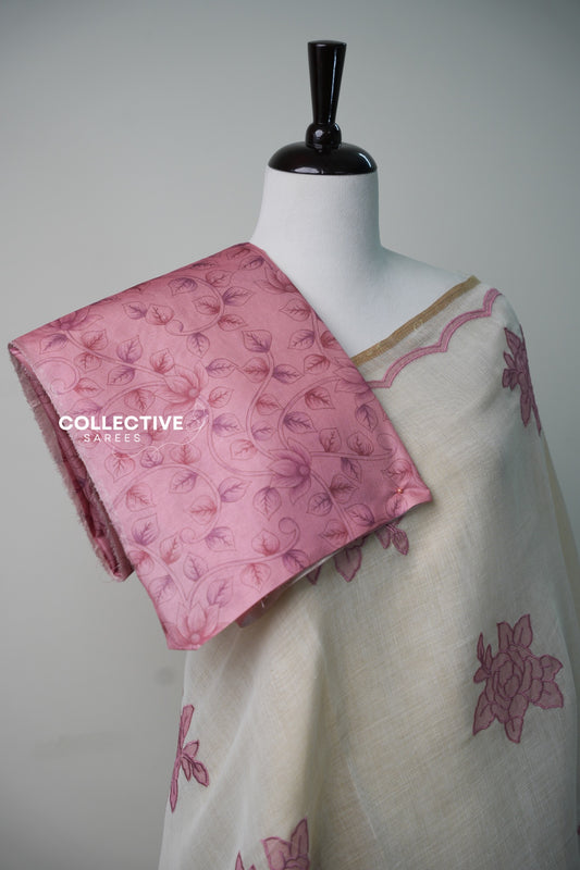 Beige soft tissue saree with pink floral appliqué work and gold-toned edging