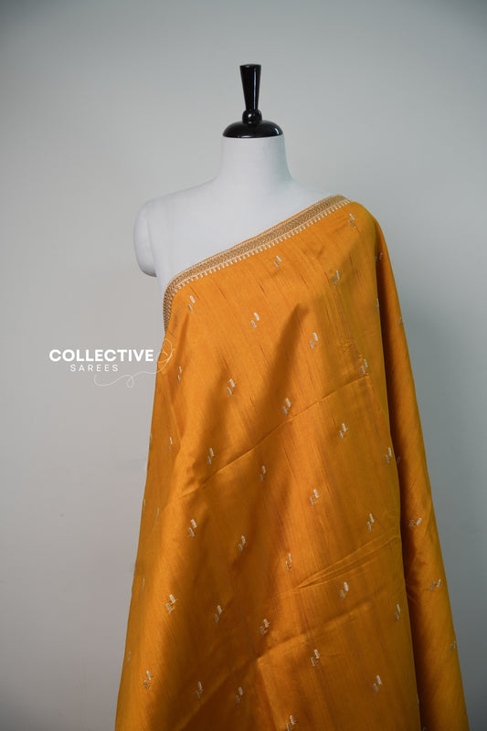 Mustard yellow semi tussar saree with embroidered leaf border close-up