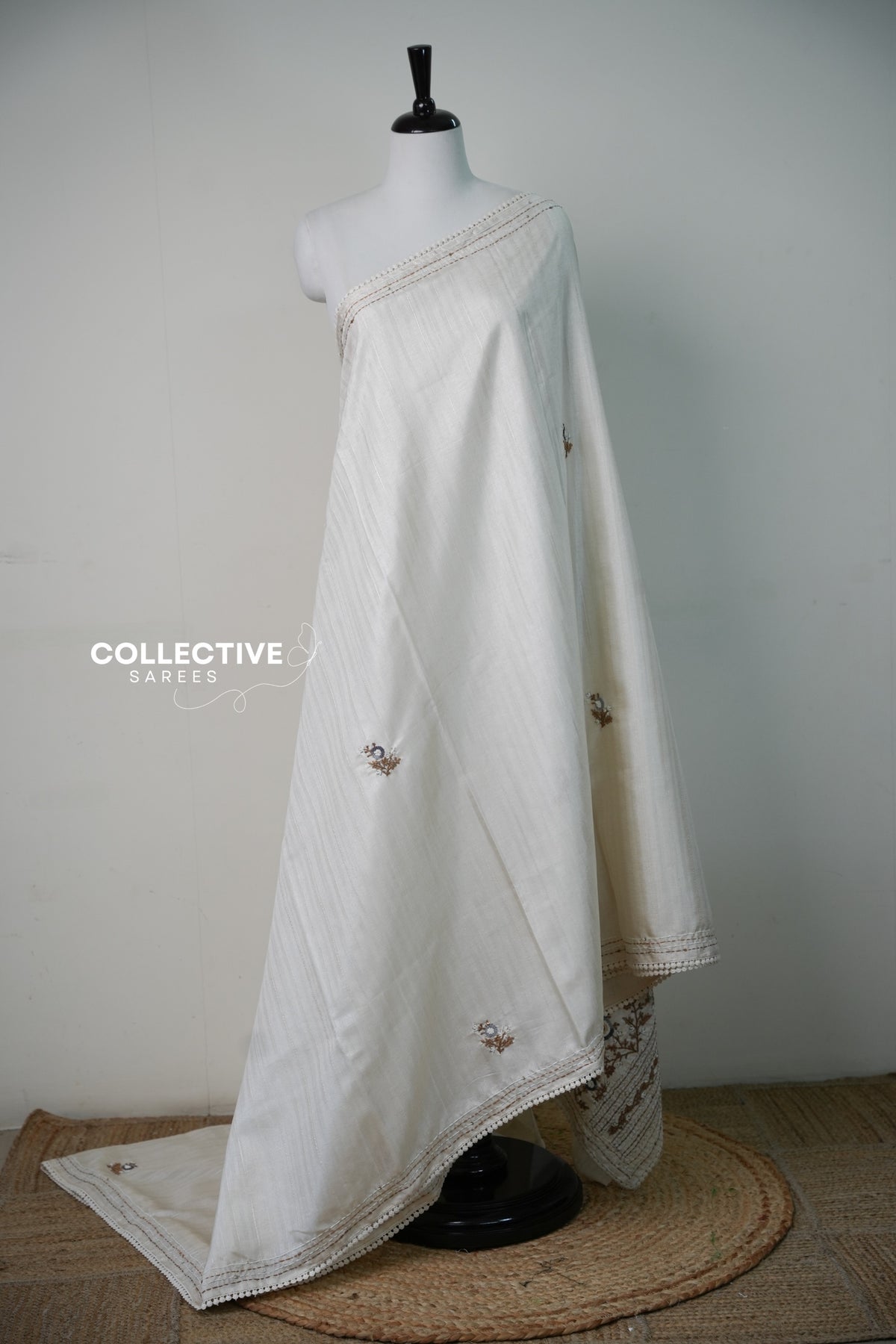 Beige dupion saree with hand-embroidered florals and lace edge, full drape