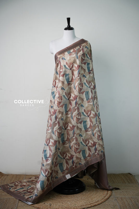 Champagne gold dupion saree with brown, rust and teal leaf print, full drape on mannequin