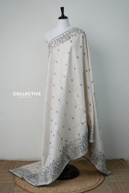 Cream silky kota saree with teal floral embroidery and lace edge, full drape