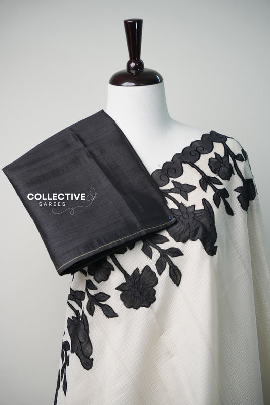 Kota off-white saree with black floral appliqué work — blouse and border detail