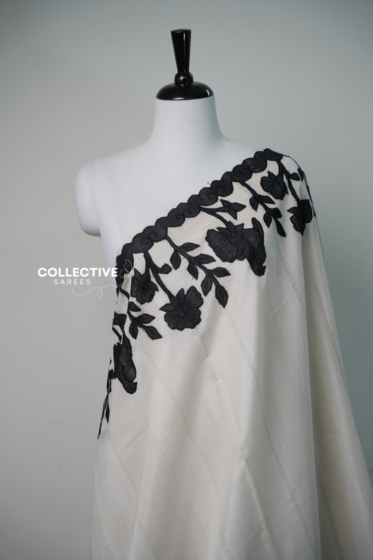 Kota off-white saree with black floral appliqué work — front view