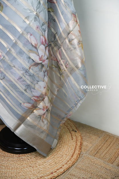 Ash organza saree pallu with magnolia blooms and silver-gold border