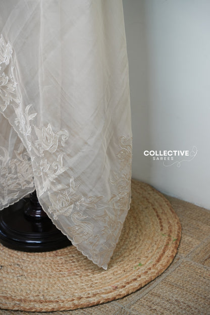 Beige organza saree with floral and bird border