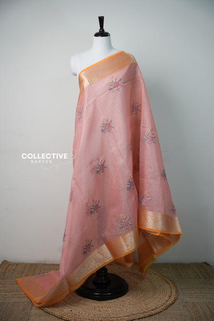 Salmon peach organza saree with orange zari border and embroidered roses, full drape