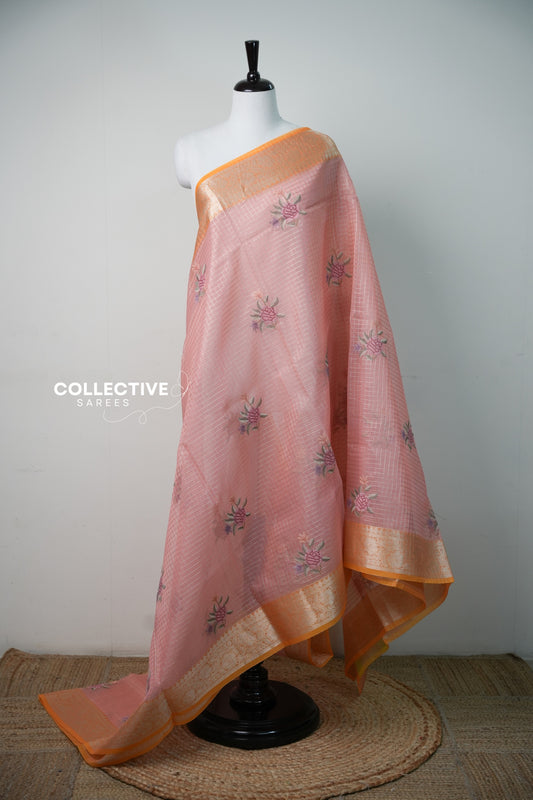 Salmon peach organza saree with orange zari border and embroidered roses, full drape