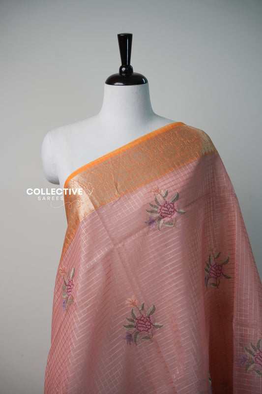 Salmon peach organza saree with silver checks and rose embroidery close-up