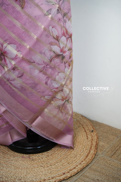Pink organza saree pallu with magnolia blooms and rose-gold tissue border
