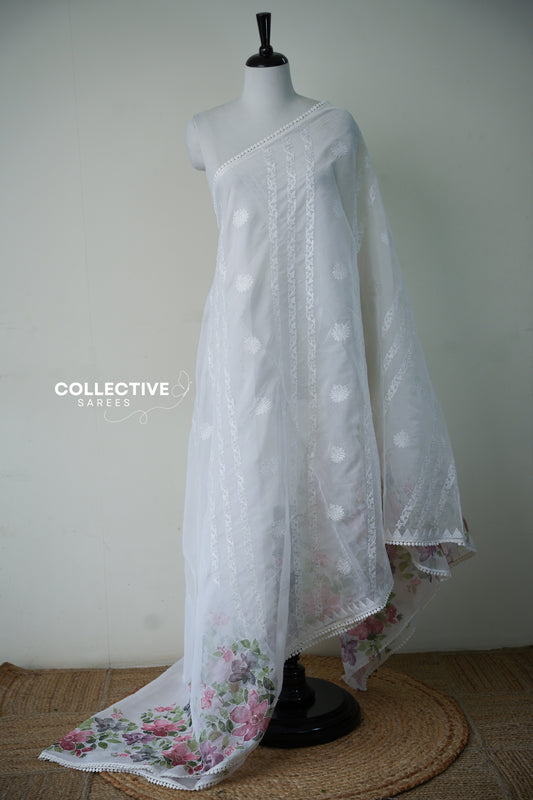 White organza saree with embroidered vine stripes and watercolour floral pallu, full drape on mannequin