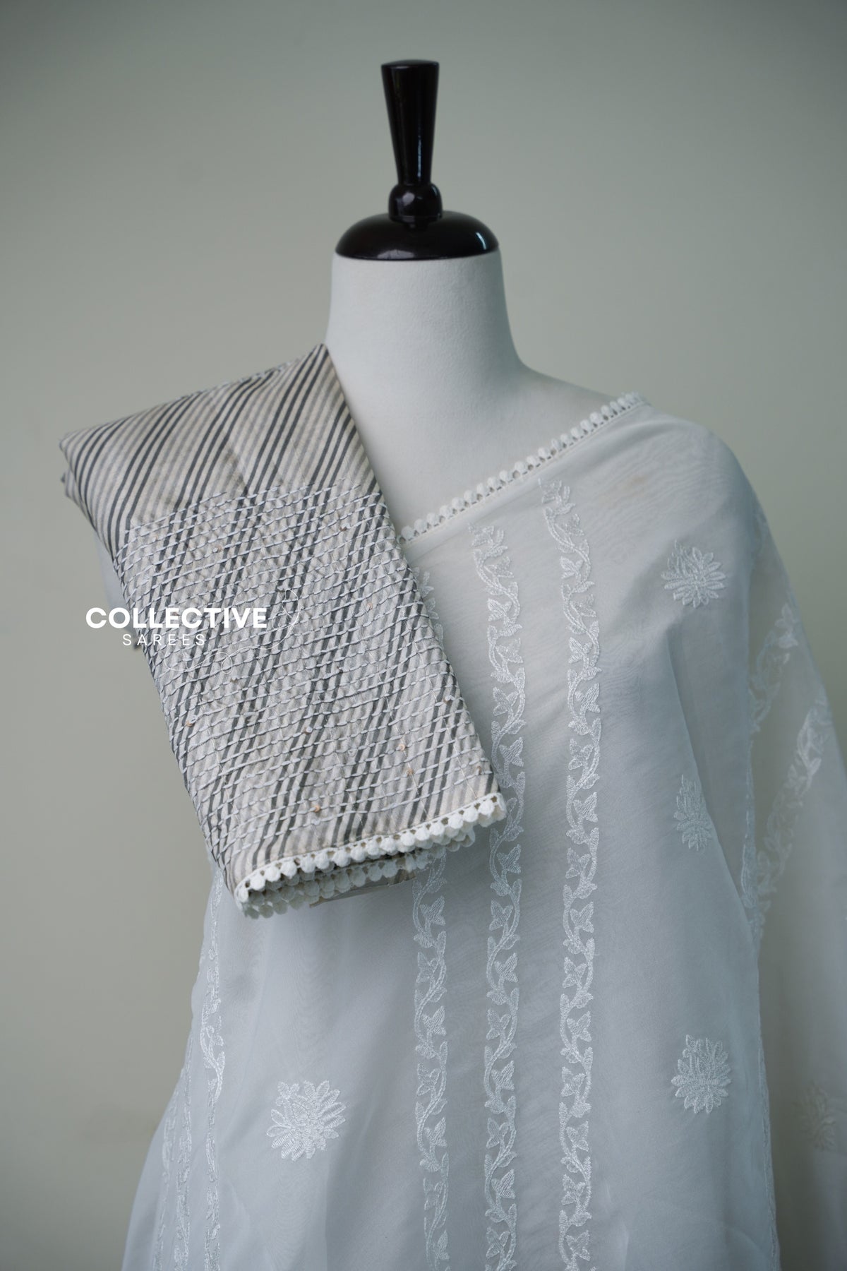 Grey and ivory striped embroidered blouse piece with lace trim on white organza saree