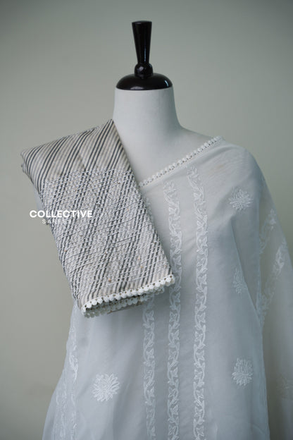 Grey and ivory striped embroidered blouse piece with lace trim on white organza saree