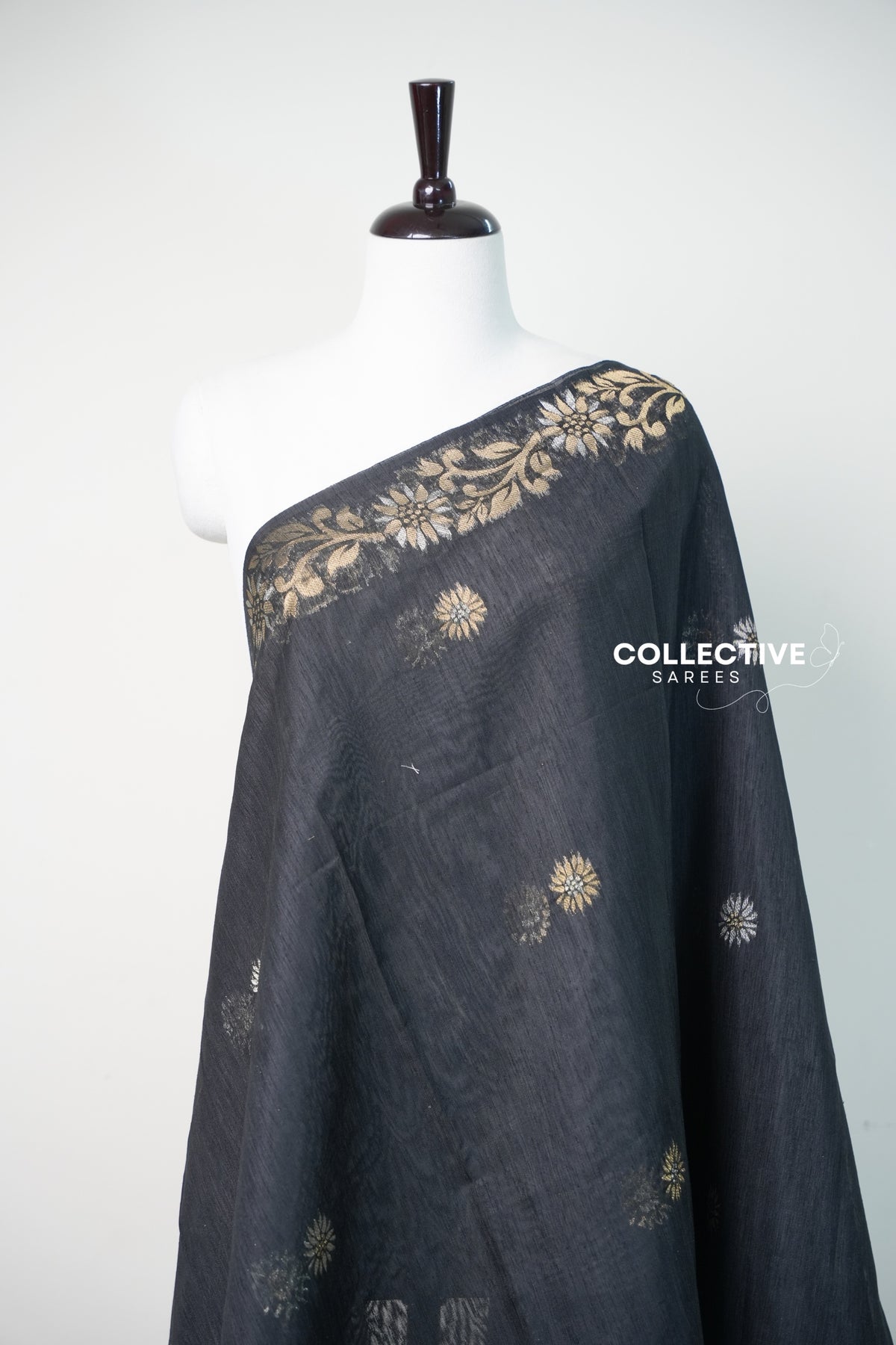 Black semi jute silk saree with gold and silver woven floral buttis