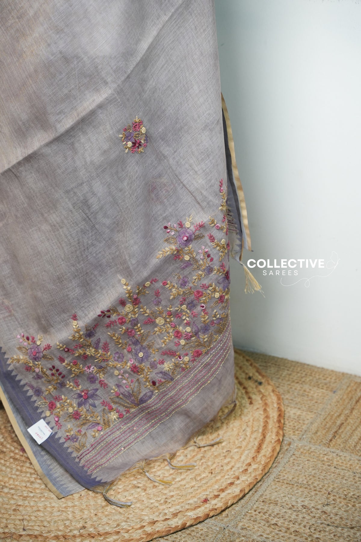 Light ash semi tissue saree pallu with rose, plum and gold floral embroidery and tassels