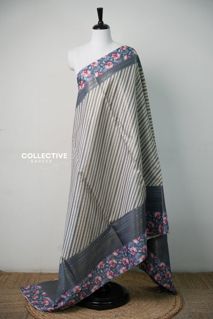 Soft tissue saree in dark ash with cream stripes and floral border — full view