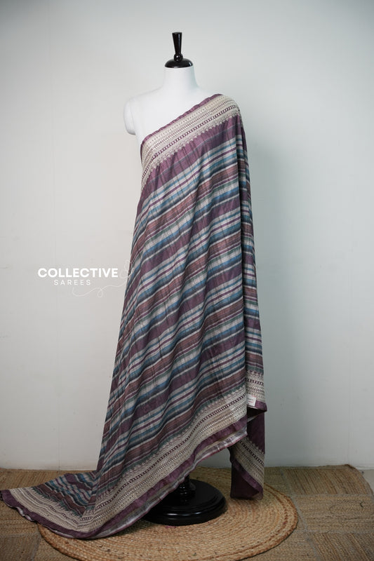 Plum semi tussar saree with multicolour diagonal stripes and ivory embroidered border, full drape